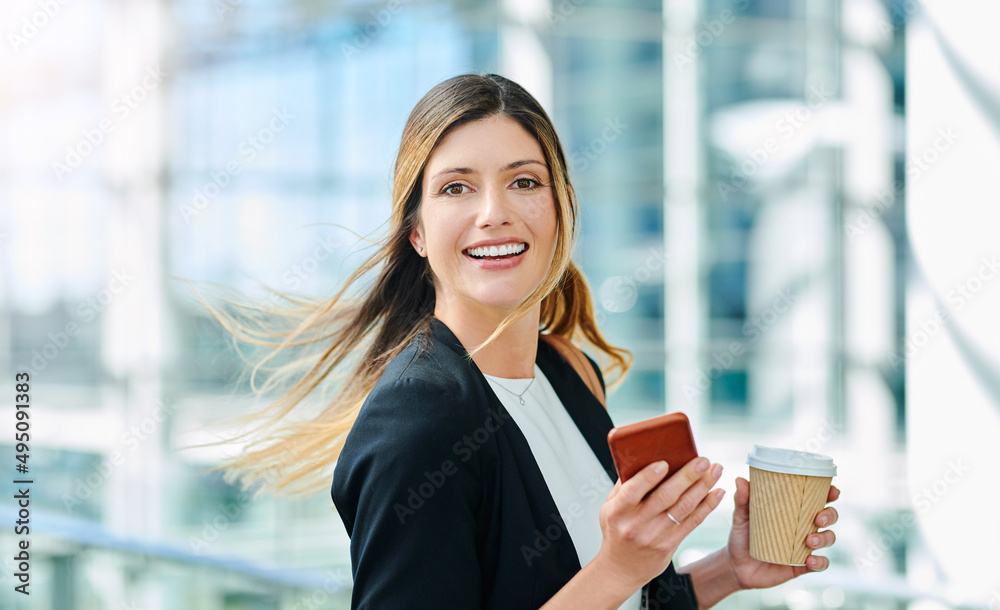 Sticker Shes always on the go. Cropped portrait of an attractive young businesswoman smiling while walking through a modern office.