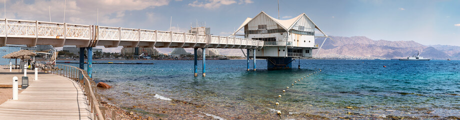 Panoramic view of bridge in the Red Sea with walking promenade leading to resort hotels