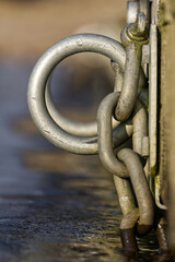 Metal rings on bridge with icy water