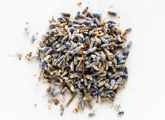 pile of dried herbal tea from natural lavender flowers close up on gray plate