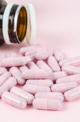 Pink capsule pills with bottle