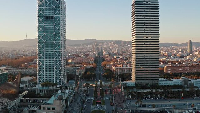 Aerial wide angle view from drone of the highest two skyscrapers in Barcelona Hotel Arts and Torre Mapfre buildings. Panorama of urban residential business and historic districts is on background