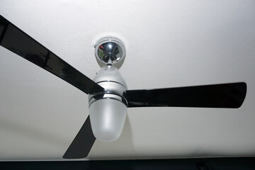 Ceiling fan indoors in   room. Closeup . Electric irony ceiling fan . 
