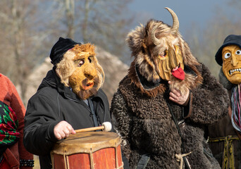 Traditional masks in Rumsiskes, Lithuania during Uzgavenes, a Lithuanian folk festival during carnival, seventh week before Easter - obrazy, fototapety, plakaty