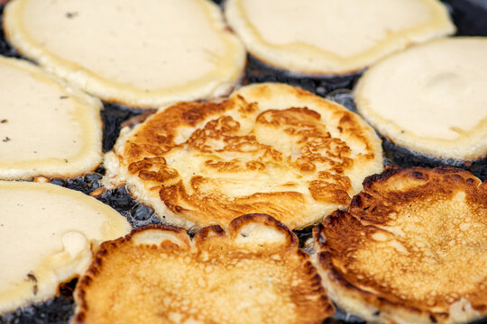 Blini, blin or blynai, pancakes traditionally made from wheat or buckwheat flour and served with smetana, tvorog, butter, caviar and other garnishes, preparing outdoor on an open fire