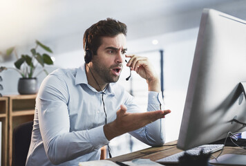 How did that happen. Shot of a young call centre agent looking upset while working late in an office.