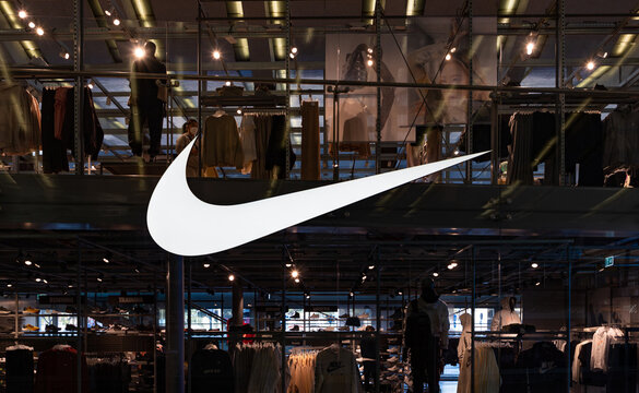 Rome, Italy - March 4, 2022: A picture of the large Nike logo on the window of a clothing store.