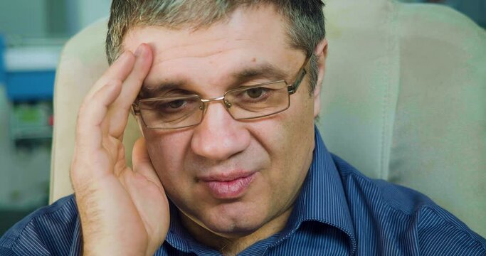 A 50 year old man is disappointed, looks at the camera and shakes his head. He got bad news.