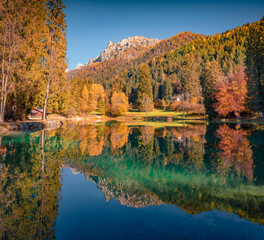 Calm morning view of Welsperg lake. Splendid autumn scene of Tonadico, Province of Trento, Italy, Europe. Astonishing landscape of Dolomite Alps. Beauty of nature concept background.