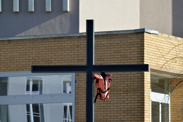 A rescue backpack hanging on a christian cross in Berlin-City.