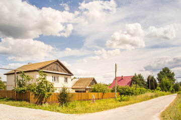Large brick house at the intersection of streets  at summer