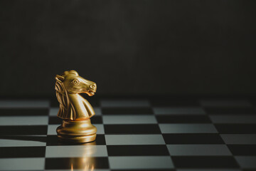 Golden knight chess standing on a board. business, success, leadership concept.