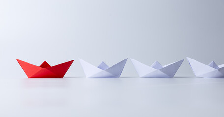 Leadership and teamwork concept, Red paper ship leading among white