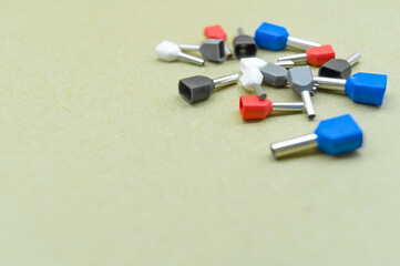 Coloured crimp terminals for different wire sizes. Copper sleeves for crimping electrical cables. Ferrules. Selective focus, copy space