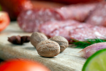 a whole nutmeg on a wooden board