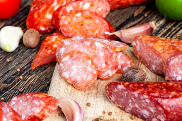 sliced pieces of sausage from meat are lying on a cutting board