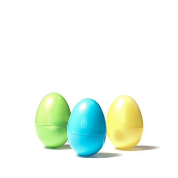 Three Colored Plastic Easter Eggs on White Background Green Blue Yellow Spring in April