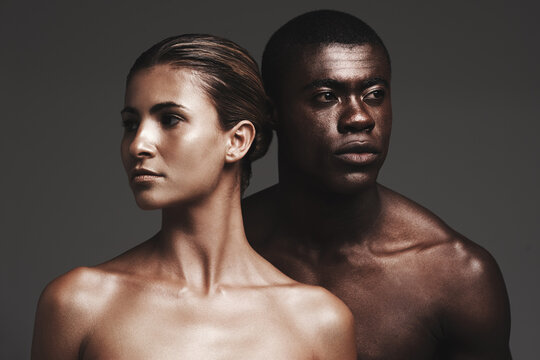 Shine Together. Shot Of A Beautiful Couple Posing In A Studio - Gray Background.