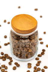 Glass jar with coffee beans on white background. Close up of coffee.