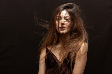 Beauty portrait of a beautiful girl with makeup and long hair