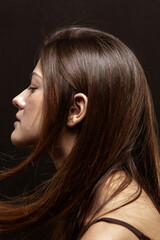 Naklejka premium Beauty portrait of a beautiful girl with makeup and long hair