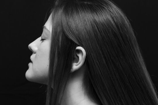 Beauty portrait of a beautiful girl with makeup and long hair