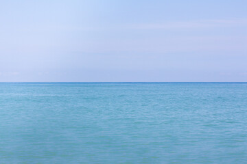 Obraz premium Blue calm sea and blue sky horizontal background for copy space. 