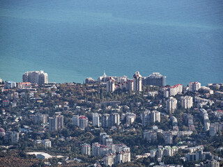 Aerial view of city with residential houses at sea water background. Seaside resort