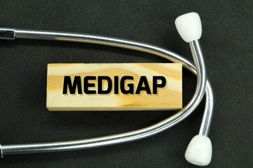 stethoscope and wooden board with the word medigap