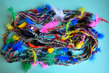 background of knitting wool with easter theme featuring feathers and chicken 