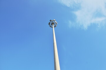 electric lamp pole structure on blue sky background in sunny day