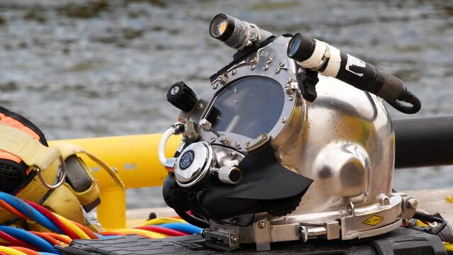 Professional diver working underwater with welding tools. Deep sea diving equipment, underwater engineering works.