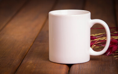 white mug on a wooden table mockup