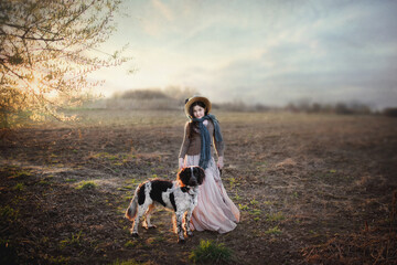 dziewczynka w starodawnym stroju z psem na spacerze - obrazy, fototapety, plakaty