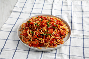Homemade One-Pot Garlic Tomato Shrimp Pasta on a Plate, side view.