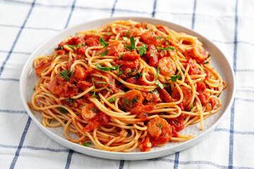 Homemade One-Pot Garlic Tomato Shrimp Pasta on a Plate, side view. Close-up.