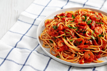 Homemade One-Pot Garlic Tomato Shrimp Pasta on a Plate, side view. Space for text.