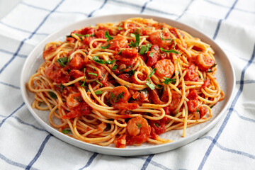 Homemade One-Pot Garlic Tomato Shrimp Pasta on a Plate, side view.