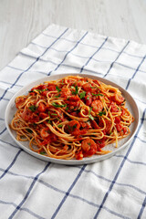 Homemade One-Pot Garlic Tomato Shrimp Pasta on a Plate, side view.