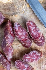 sliced pieces of sausage from meat are lying on a cutting board