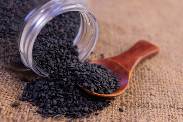 Black sesame seeds in a jar. Close-up.