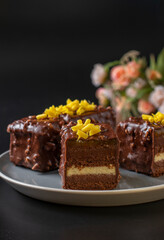 Chocolate almond brownie with mango and passionfruit jam covered gourmet chocolate glaze on black background