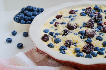 Raw organic eco friendly gluten free pie with blueberries and other fresh berries on a linen napkin. Minimalistic simple natural light flat lay template. Superfood. Organic eco health care. Vitamins. 