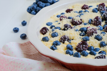 Raw organic eco friendly gluten free pie with blueberries and other fresh berries on a linen napkin. Minimalistic simple natural light flat lay template. Superfood. Organic eco health care. Vitamins. 
