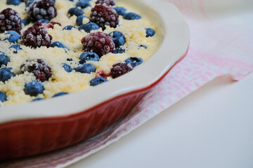 Raw organic eco friendly gluten free pie with blueberries and other fresh berries on a linen napkin. Minimalistic simple natural light flat lay template. Superfood. Organic eco health care. Vitamins. 