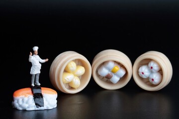 miniature figurine of a chef with Japanese food