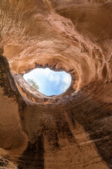A cave where the ancestors lived. Cave in the Grand Canyon. An ancient cave. Natural window made of stone. eroded cave