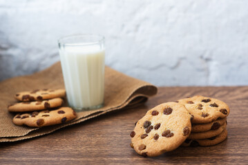 Fragrant, tasty, homemade cookies with raisins and a glass of fresh milk on the table