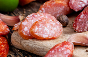 sliced pieces of sausage from meat are lying on a cutting board