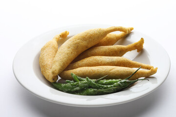 Crispy Green Chilli Pakora or Mirchi Bajji, served with tomato ketchup  Its a popular tea time snack from India especially in Monsoon